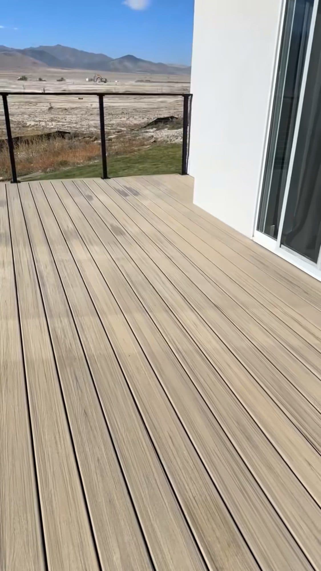 Composite deck boards beside a modern home