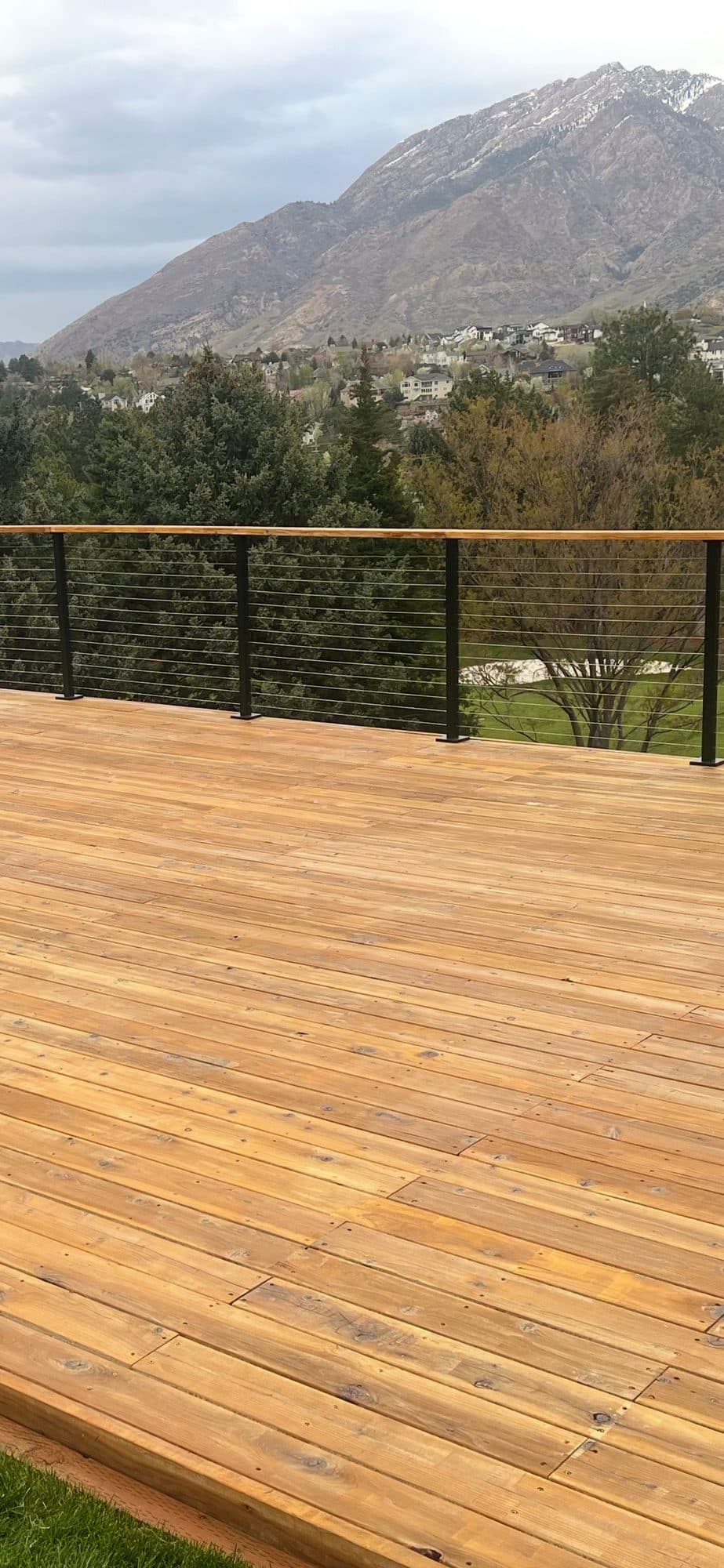 New wood deck with cable railing and mountain views