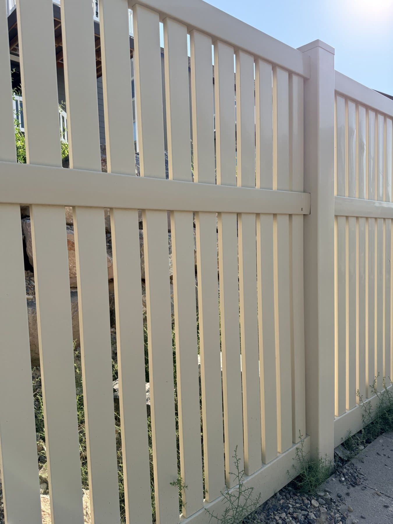 Tan vinyl semi-privacy fence close-up