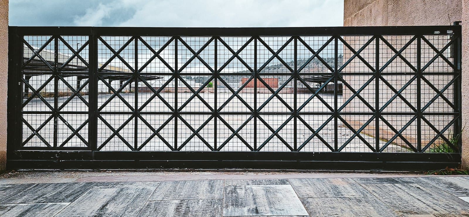 Black steel gate with a geometric pattern