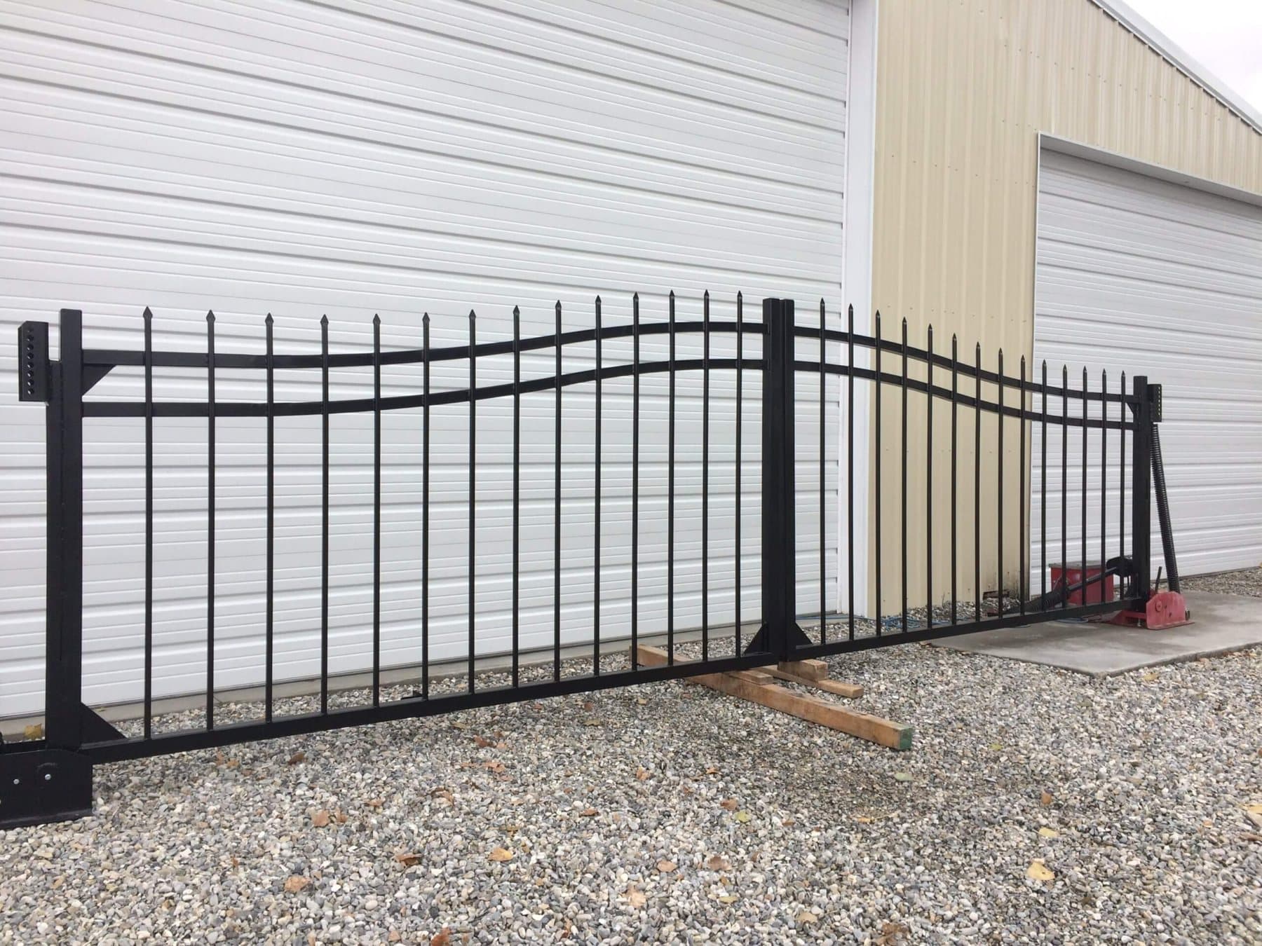 Black iron gate with an arched picket top