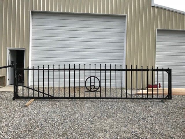Black iron gate with a custom monogram panel