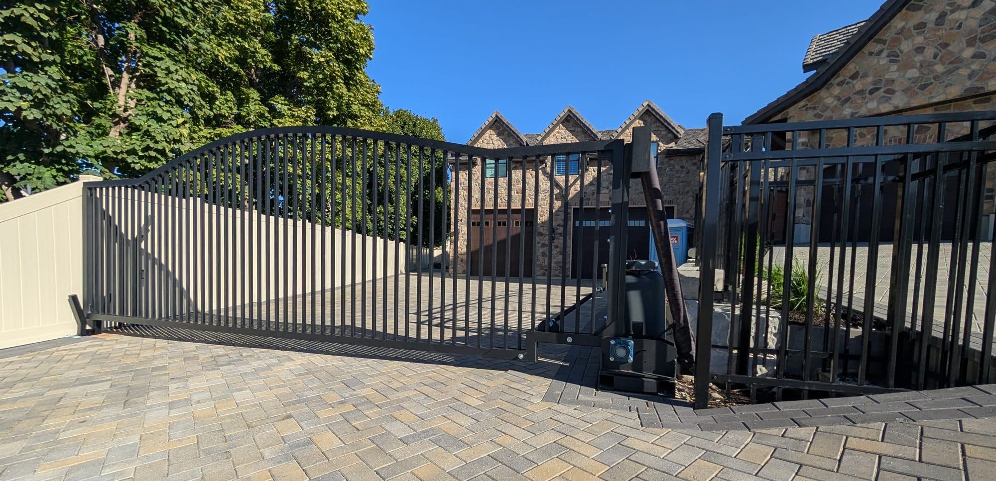 Custom arched iron gate at a stone estate home